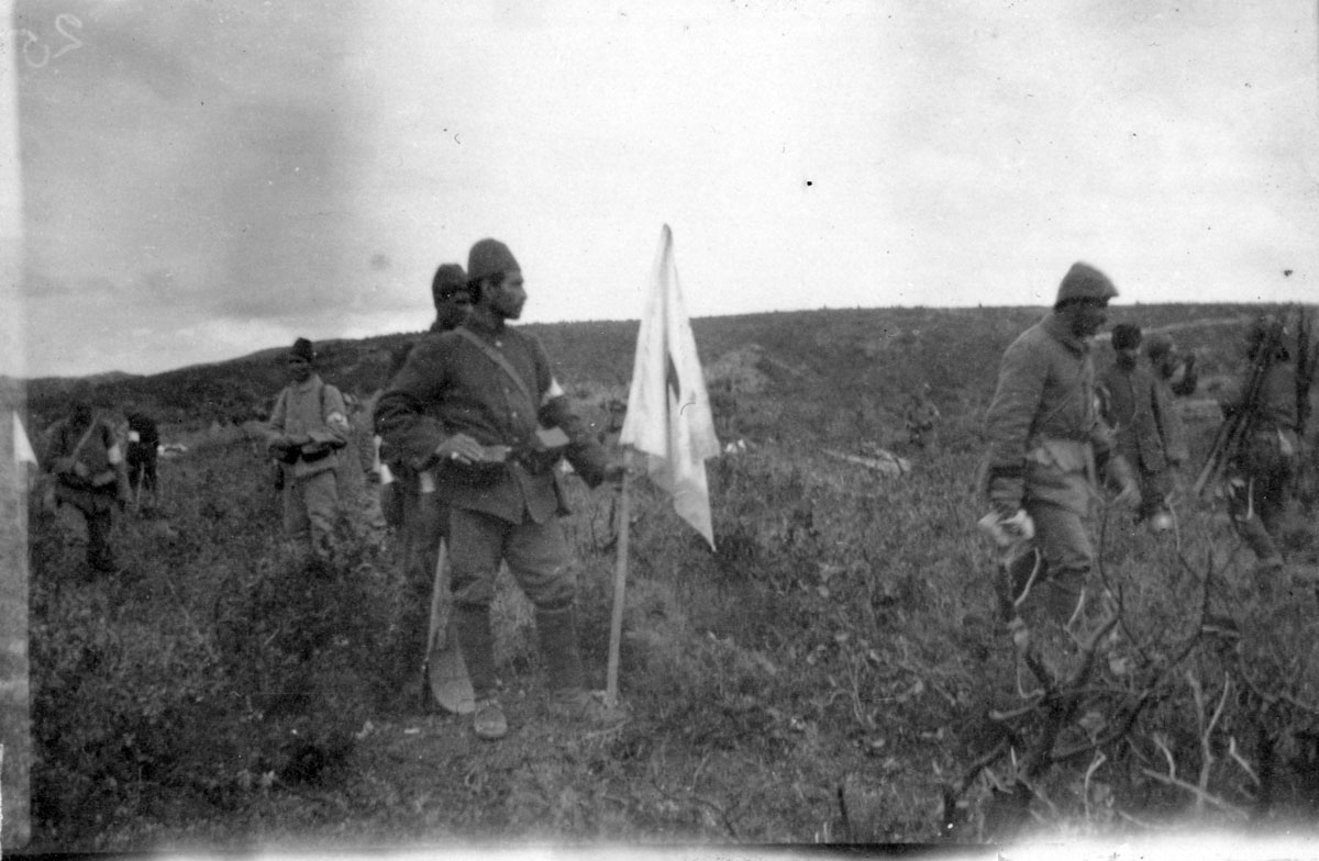 Turkish soldiers during the truce of 24 May 1915, with a white flag marking the boundary between the sides.